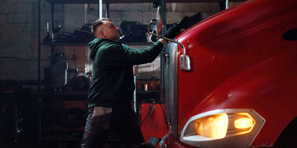 Mechanic opening the front of a Heavy Vehicle