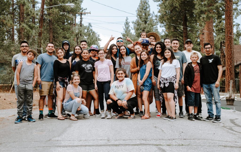 group of diverse Science manufacturing technician apprentices in team outing photo with family members