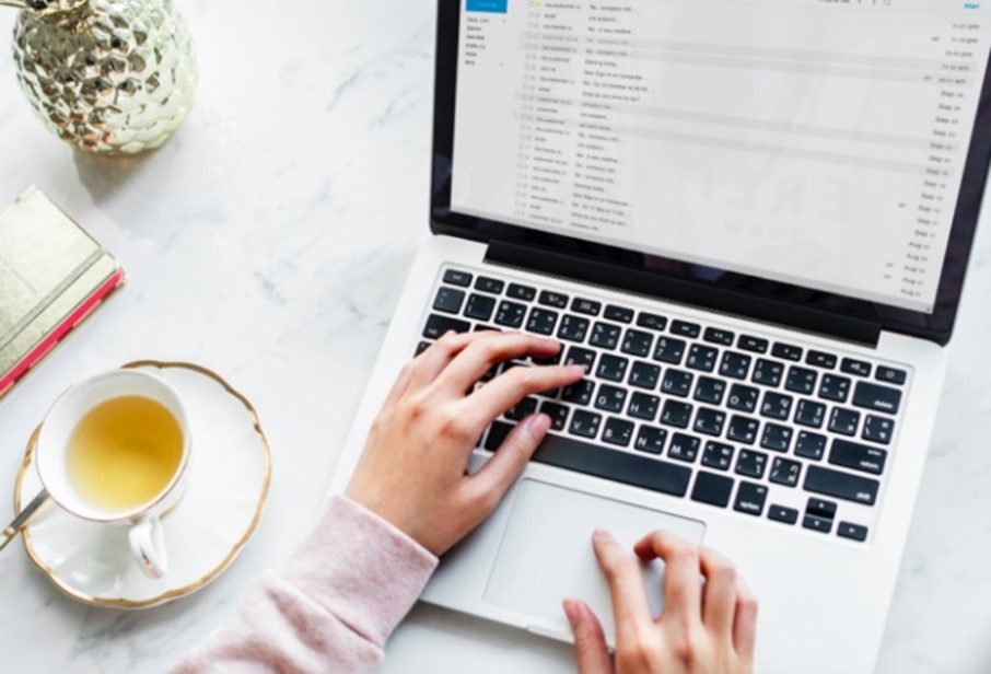 email creation, women typing on laptop