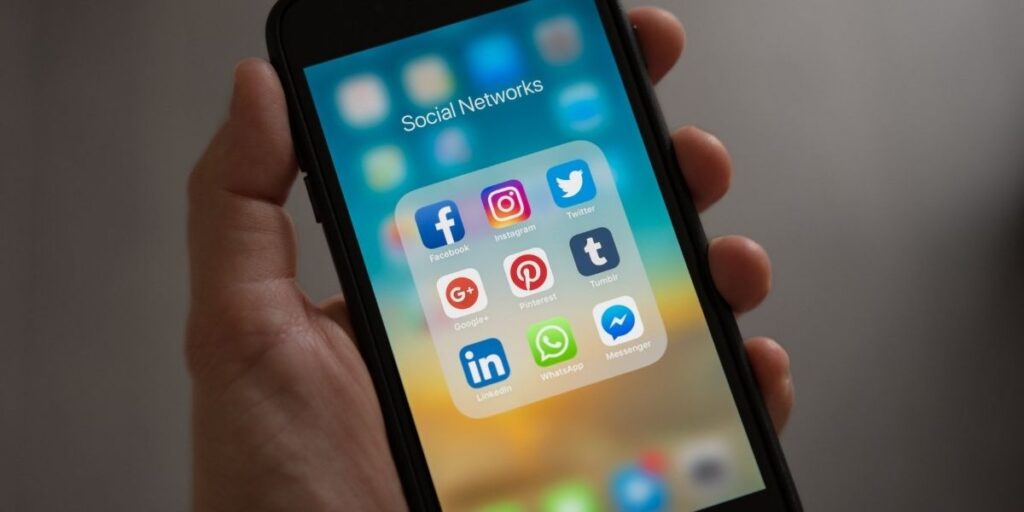Image of an iPhone showing different social media platforms 