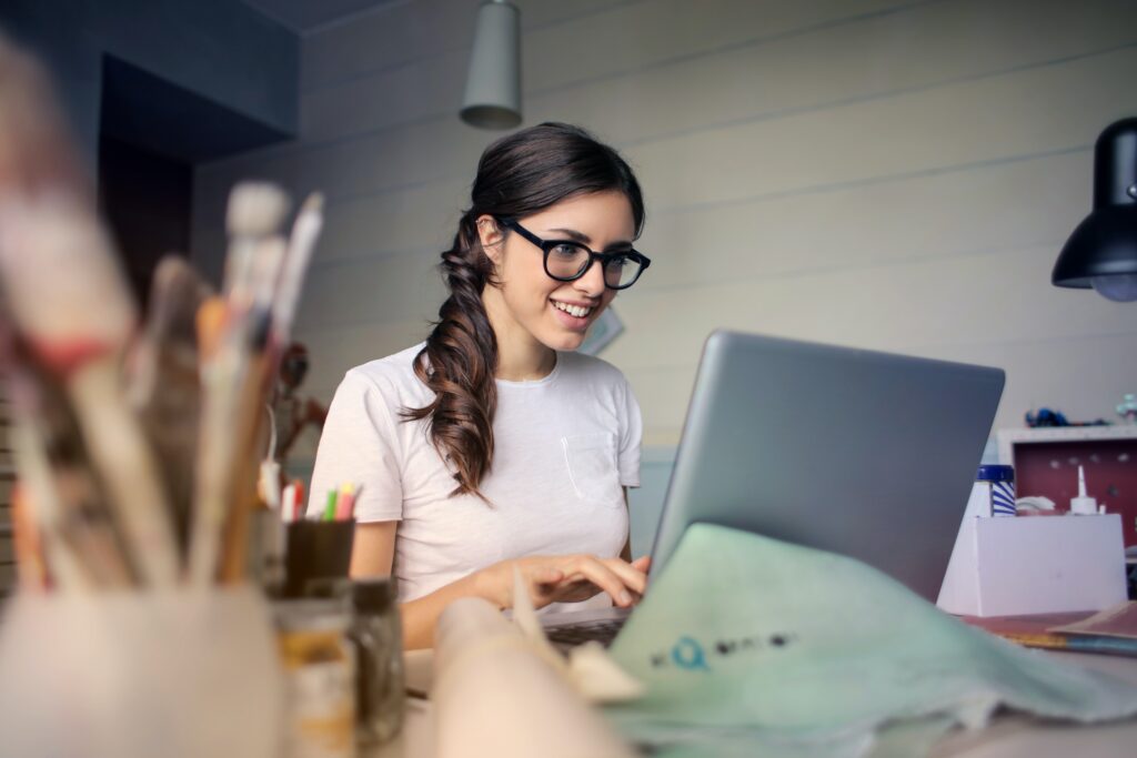 young woman using laptop, email creation, marketing tips
