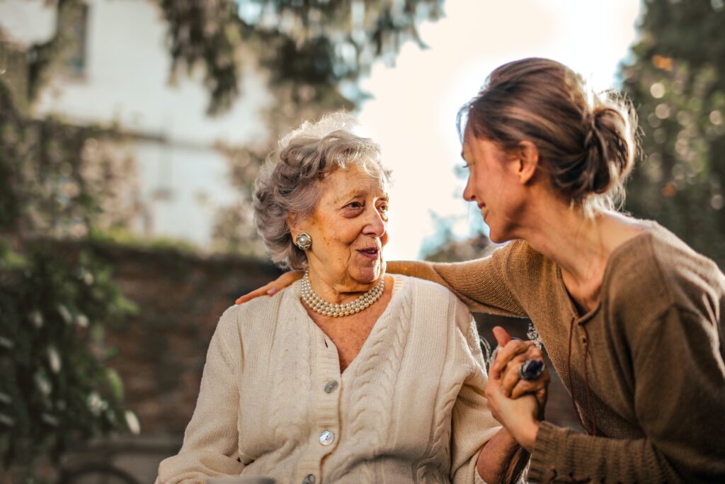 Adult Care Worker supporting elderly woman