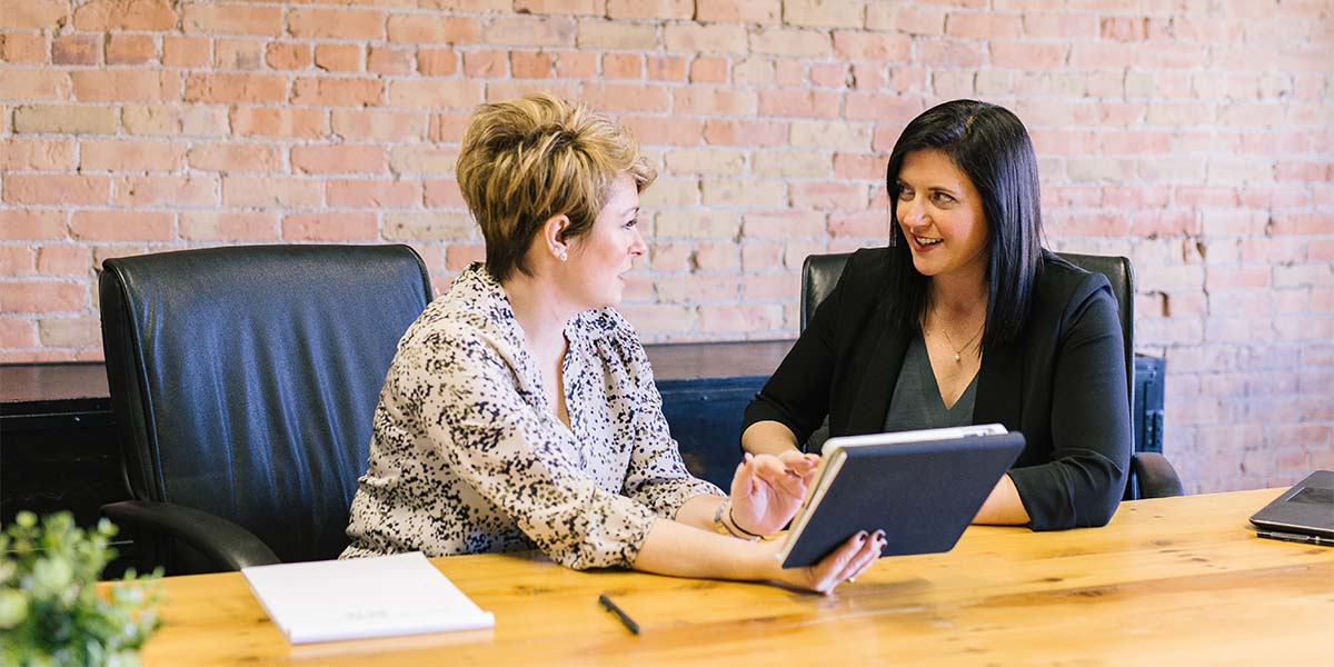 A recruiter is discussing a client’s job opportunity with a potential candidate.