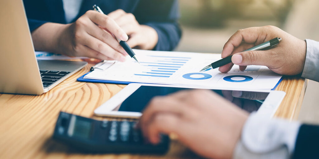 Two businessman discussing a data analysis report