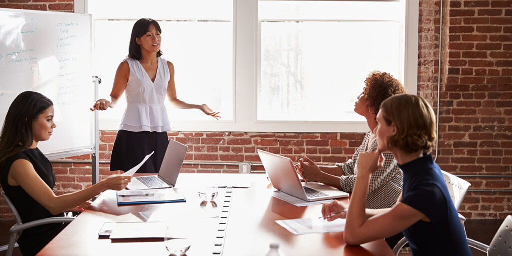 Group Of Businesswomen Meeting In Modern Boardroom