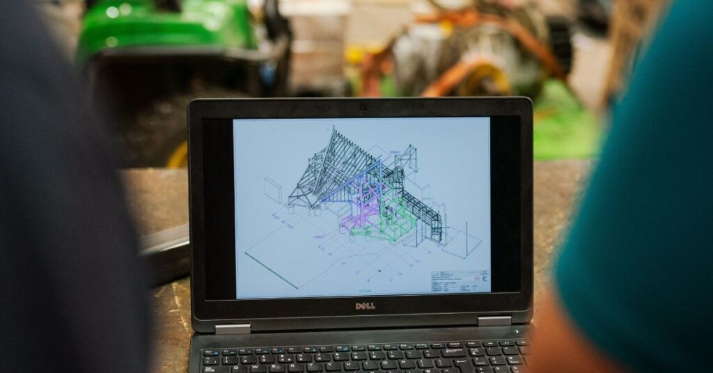 Female civil engineer discusses theme park attraction plans on a laptop