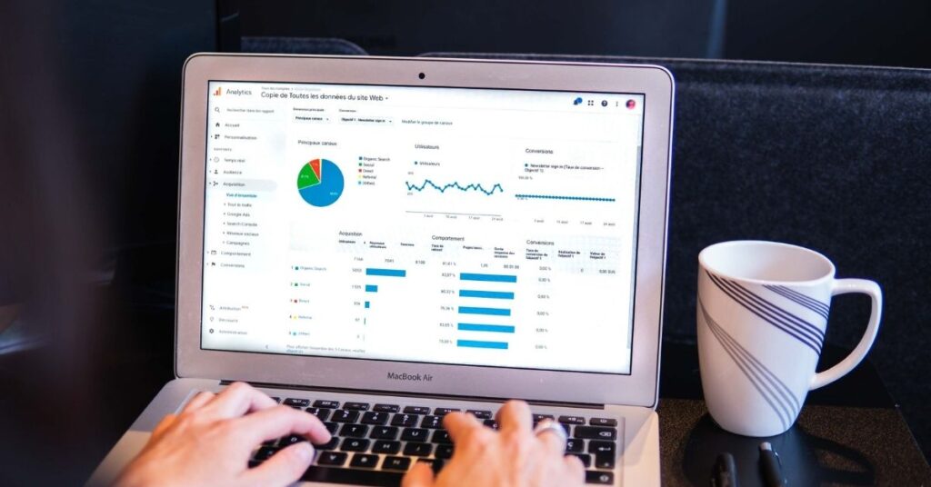 Photo of someone working on a laptop with a Google Analytics report.