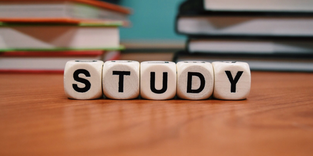 the word study written across 5 dices - each letter per dice