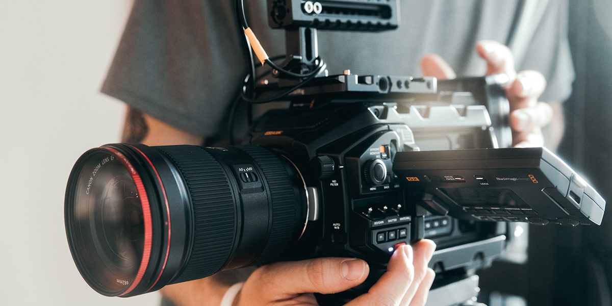 Person using a professional camera to create content