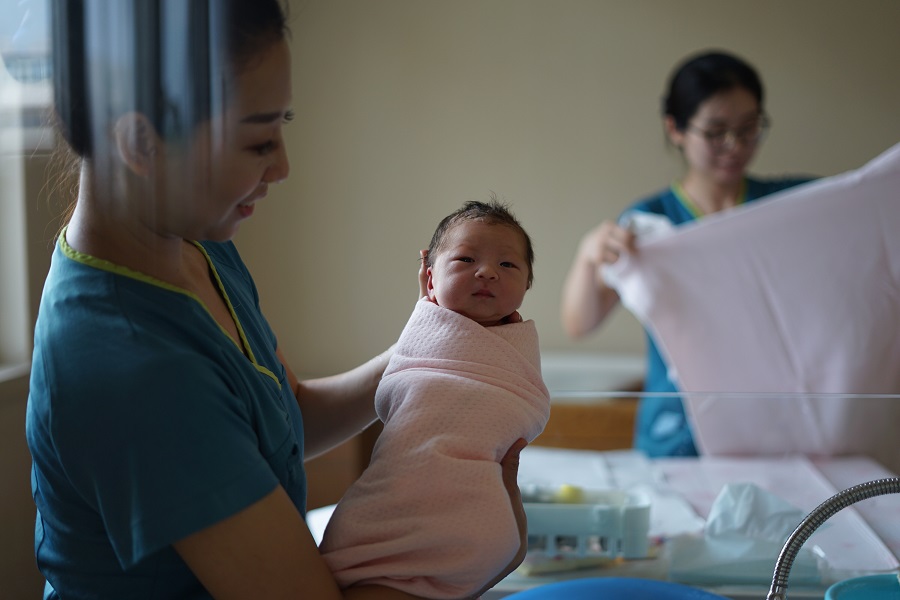 Midwife holding a baby 