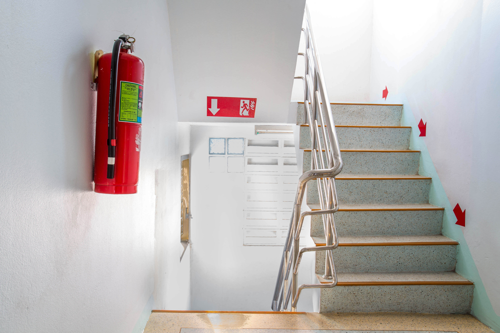 Fire safety image with fire exit signs and fire extinguisher.