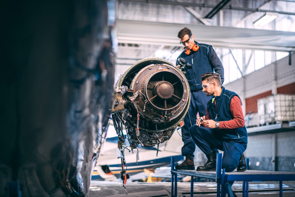 Two males working on an aircraft
