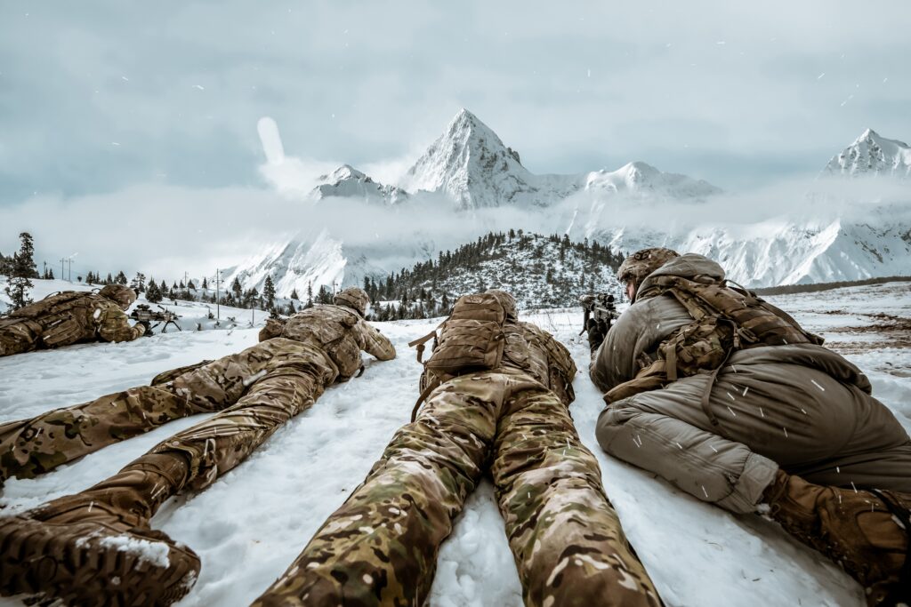 Soldiers laying prone in the snow