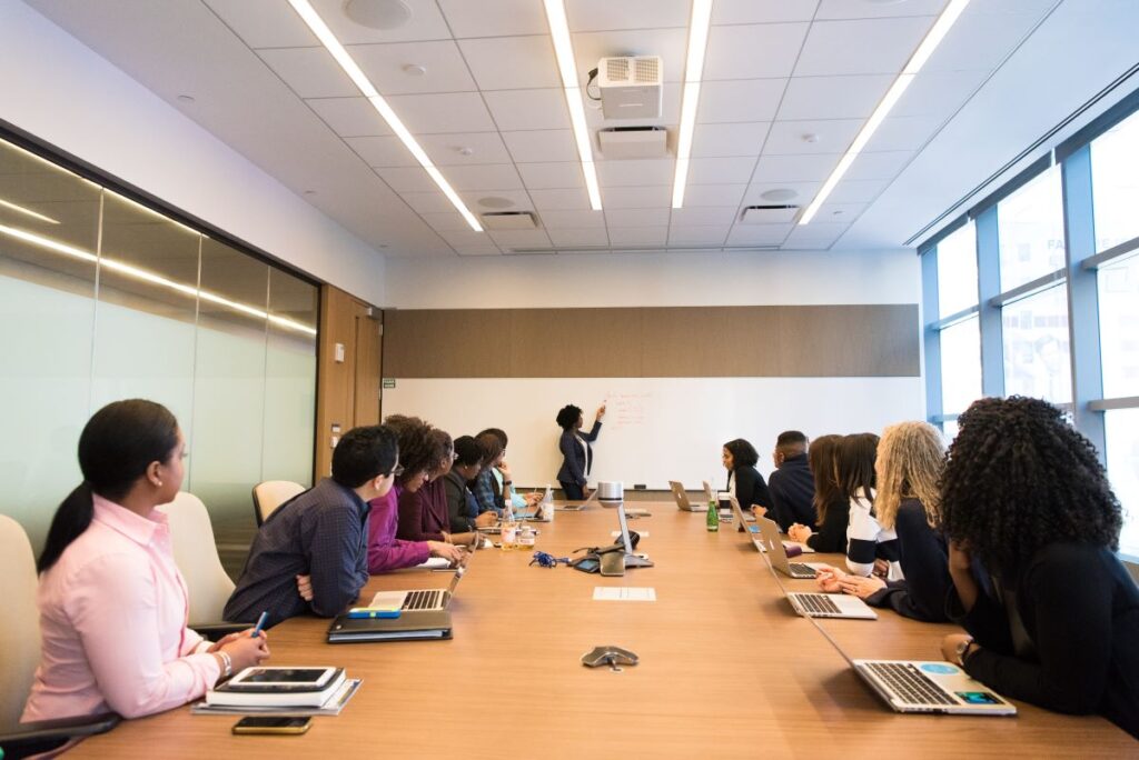 Photo showcasing an office team environment similar to that of a compliance officer team meeting
