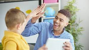 Early Years Lead Practitioner and child giving each other high five