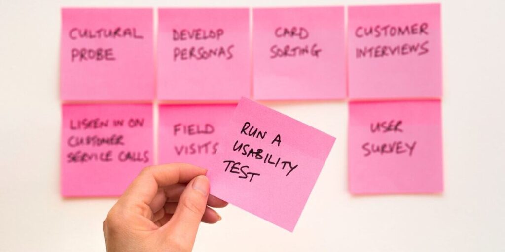 UX apprentice using sticky notes to brainstorm a process of UX design and development