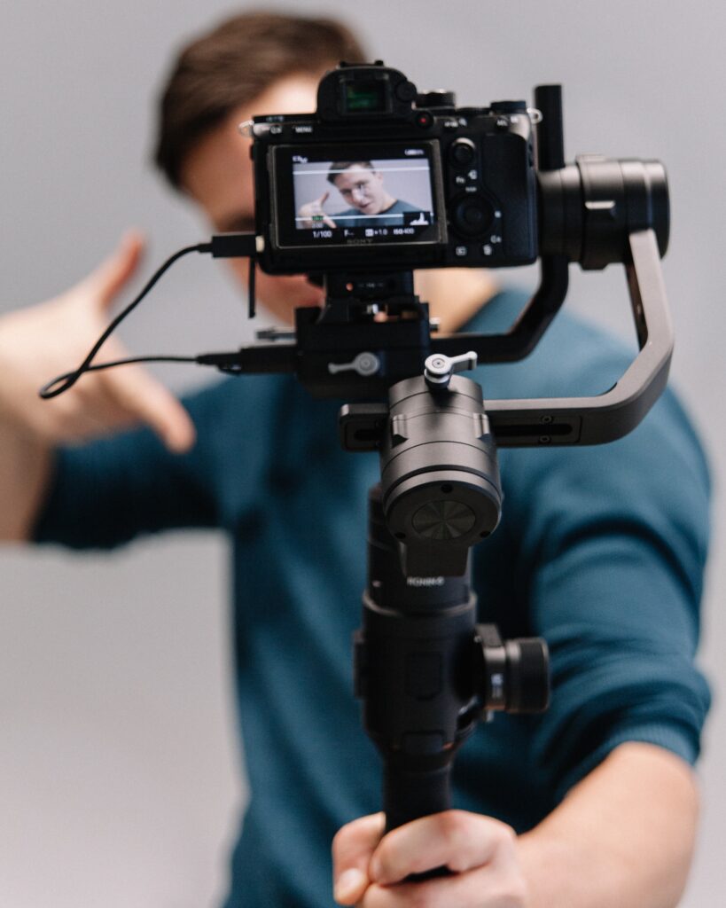 Man holding camera facing towards him