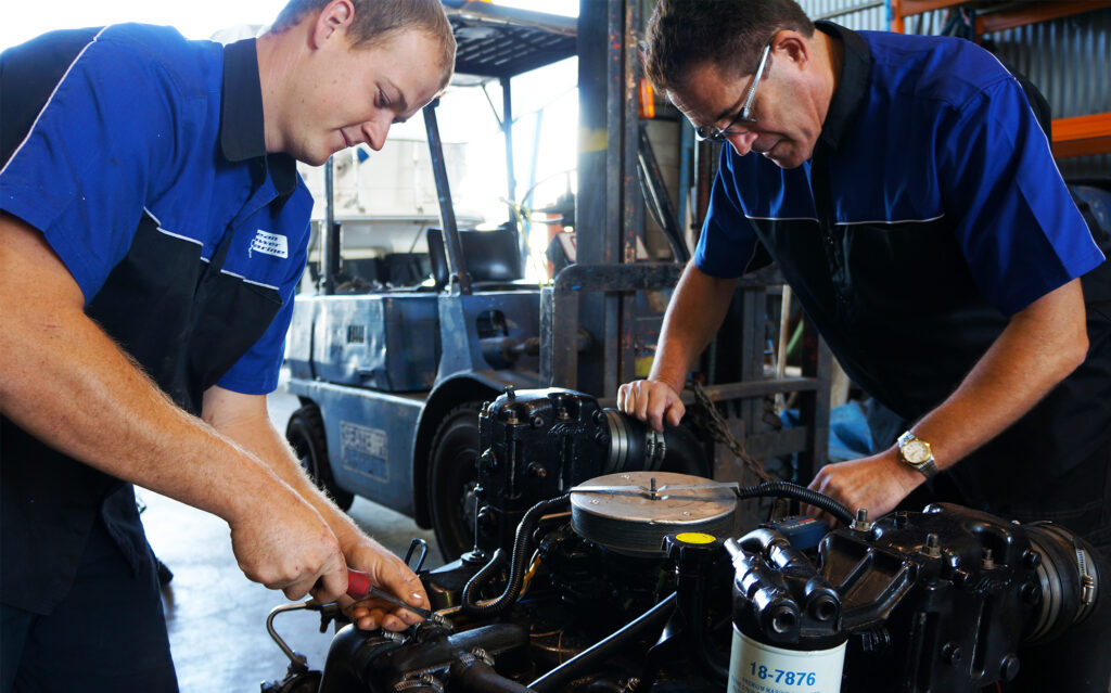 Two mechanics undertaking tests on equipment 