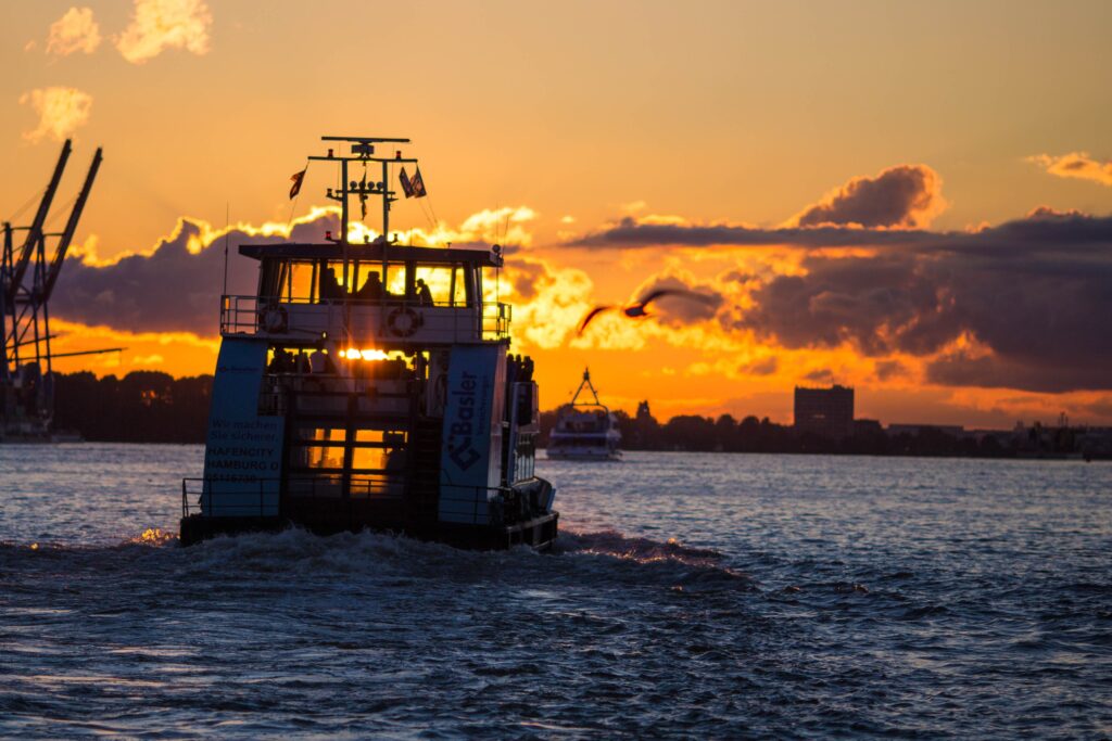 a boat at sea during golden sunset