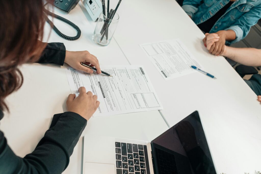 A financial advisor helping a couple during a meeting.